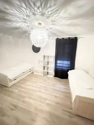 Un ou plusieurs lits dans un hébergement de l'établissement Bale 23 Magnifique Logement 6 Pers Parking Prive