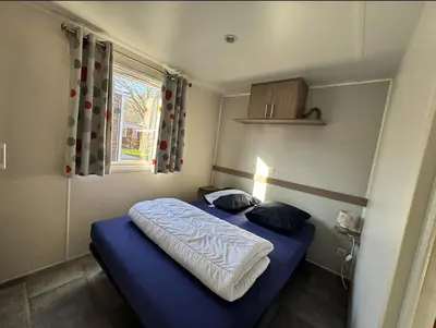 Un ou plusieurs lits dans un hébergement de l'établissement Grand MobilHome 6 Places Climatisé