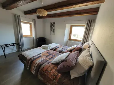 Un ou plusieurs lits dans un hébergement de l'établissement Au gré des Saisons - côté terrasse