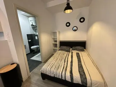 Un ou plusieurs lits dans un hébergement de l'établissement L'Atelier Urbain Apartment