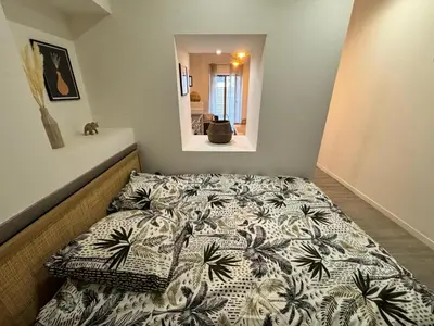 Un ou plusieurs lits dans un hébergement de l'établissement Le Nid en Rotin Apartment