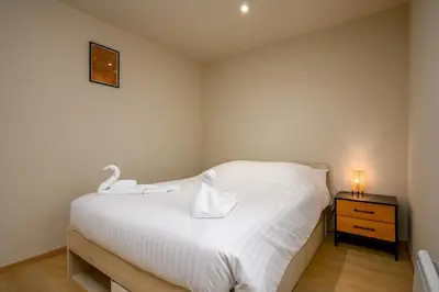 Un ou plusieurs lits dans un hébergement de l'établissement Le 60-Appart'Hôtel-GregIMMO