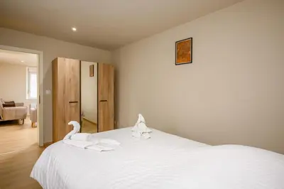 Un ou plusieurs lits dans un hébergement de l'établissement Le 60-Appart'Hôtel-GregIMMO