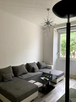 Coin salon dans l'établissement Grand appartement proche centre et tram