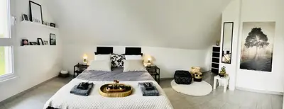 Un ou plusieurs lits dans un hébergement de l'établissement Maison et son jardin