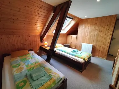 Un ou plusieurs lits dans un hébergement de l'établissement B&B Gite les Baudy