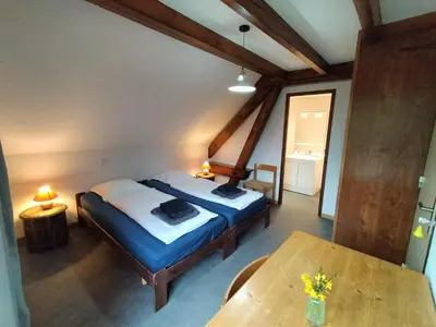 Un ou plusieurs lits dans un hébergement de l'établissement B&B Gite les Baudy