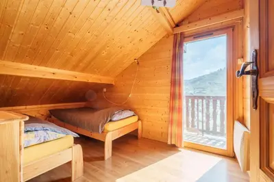 Un ou plusieurs lits dans un hébergement de l'établissement Chalet Le Bas du Paradis