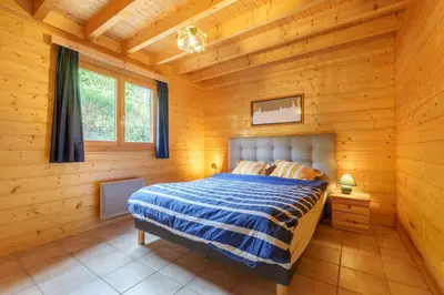 Un ou plusieurs lits dans un hébergement de l'établissement Chalet Le Bas du Paradis