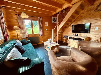 Coin salon dans l'établissement Chalet Le Meix-SaGe