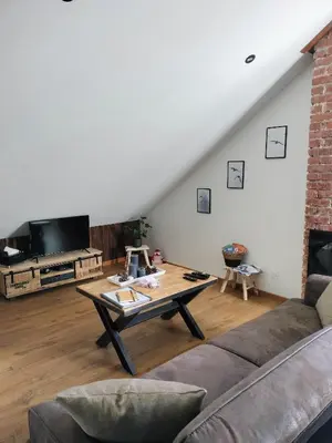 Coin salon dans l'établissement Appartement neuf Le Grenier d'Oscar