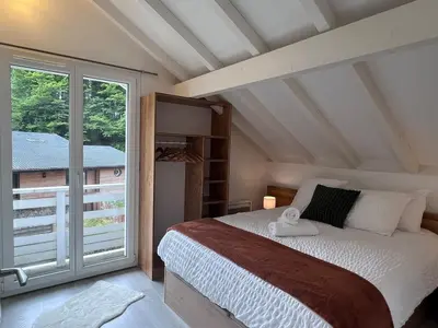 Un ou plusieurs lits dans un hébergement de l'établissement Chalet Vertpheny Spa & Terrasse à 500m du Lac de Gérardmer