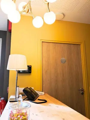 Un ou plusieurs lits dans un hébergement de l'établissement Hôtel du Cheval Blanc Brunstatt