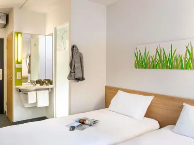 Un ou plusieurs lits dans un hébergement de l'établissement Ibis Budget Montbéliard