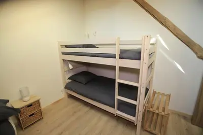 Un ou plusieurs lits dans un hébergement de l'établissement Le Chalet de la Forêt, ideal for your reunions