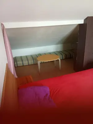 Un ou plusieurs lits dans un hébergement de l'établissement Chambre dans une appartement