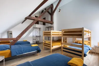 Un ou plusieurs lits dans un hébergement de l'établissement ESPLANADE Maison spa jeux cinéma Colmar