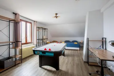 Un ou plusieurs lits dans un hébergement de l'établissement ESPLANADE Maison spa jeux cinéma Colmar