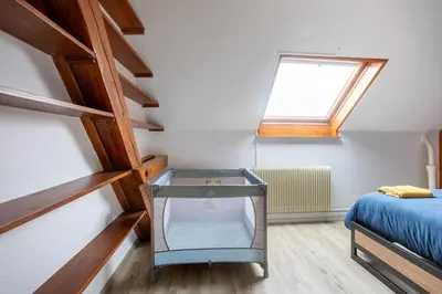 Un ou plusieurs lits dans un hébergement de l'établissement ESPLANADE Maison spa jeux cinéma Colmar