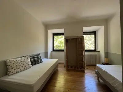 Un ou plusieurs lits dans un hébergement de l'établissement Gîte A l'Ancienne Forge - Maison avec jardin