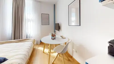 Un ou plusieurs lits dans un hébergement de l'établissement Résidence CoLiving Porte de France - Self Check In by Homenhancement