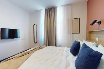 Un ou plusieurs lits dans un hébergement de l'établissement Résidence CoLiving Porte de France - Self Check In by Homenhancement