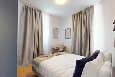 Un ou plusieurs lits dans un hébergement de l'établissement Résidence CoLiving Porte de France - Self Check In by Homenhancement