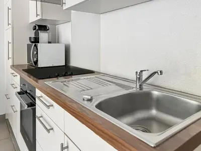 Cuisine ou kitchenette dans l'établissement Parking privé & terrasse ensoleillée