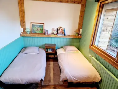 Un ou plusieurs lits dans un hébergement de l'établissement Vosges, quiet four bedroom chalet, cinema, games room