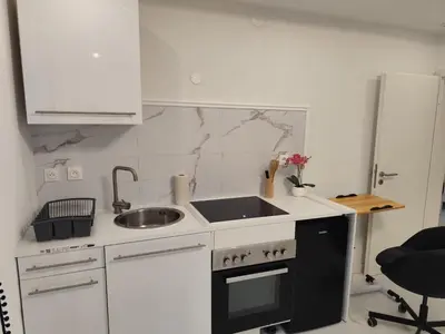 Cuisine ou kitchenette dans l'établissement Appartement meublé Rixheim Alsace