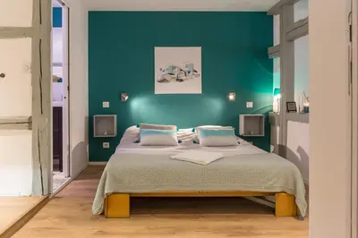 Un ou plusieurs lits dans un hébergement de l'établissement Grand studio Colmar Centre