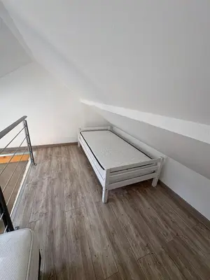 Un ou plusieurs lits dans un hébergement de l'établissement Charmant duplex aux portes de Belfort