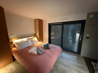 Un ou plusieurs lits dans un hébergement de l'établissement Chalet prestige avec sauna