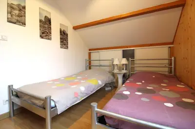 Un ou plusieurs lits dans un hébergement de l'établissement Le Chalet Vert entre nature et animations