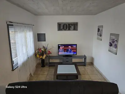 Télévision ou salle de divertissement dans l'établissement Gîtes du Moulin