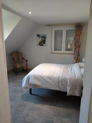 Un ou plusieurs lits dans un hébergement de l'établissement La Maison Bleue