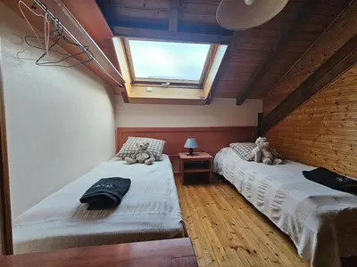 Un ou plusieurs lits dans un hébergement de l'établissement appartement le petit chalet sauna