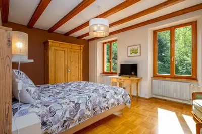 Un ou plusieurs lits dans un hébergement de l'établissement Chambres d'hôtes Le Jardin de Rosalie