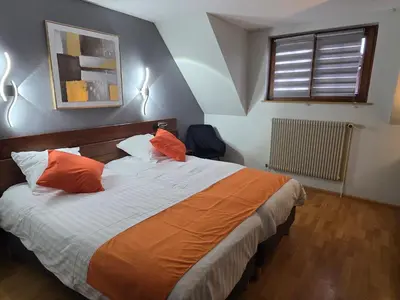 Un ou plusieurs lits dans un hébergement de l'établissement Hôtel Restaurant AU SOLEIL