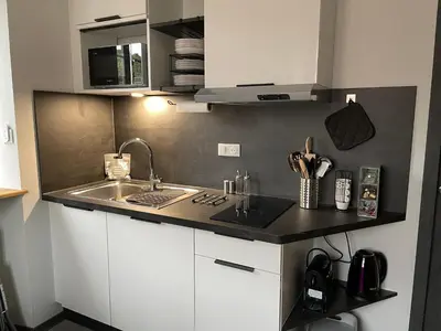 Cuisine ou kitchenette dans l'établissement Studio 3 étoiles avec grand JACUZZI PRIVÉ