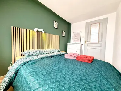 Un ou plusieurs lits dans un hébergement de l'établissement Cozy Apartment city center
