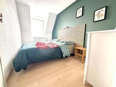 Un ou plusieurs lits dans un hébergement de l'établissement Cozy Apartment city center