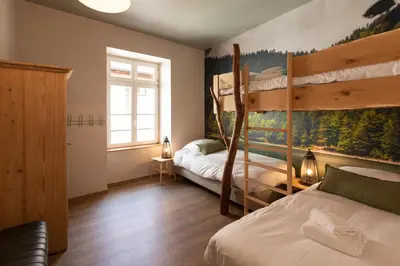 Un ou plusieurs lits dans un hébergement de l'établissement Appartement A Travers Champs avec Sauna et Parking