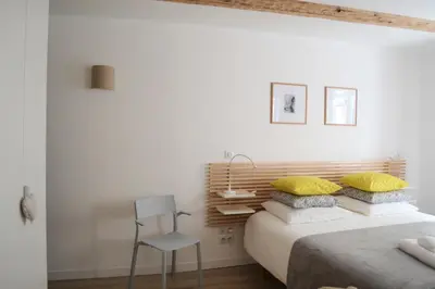 Un ou plusieurs lits dans un hébergement de l'établissement Studio Maison Verte Colmar Centre