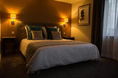 Un ou plusieurs lits dans un hébergement de l'établissement Les Chambres de Louise