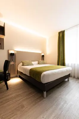 Un ou plusieurs lits dans un hébergement de l'établissement Hotel Cheval De Bronze