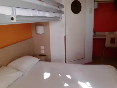 Un ou plusieurs lits dans un hébergement de l'établissement Premiere Classe Belfort