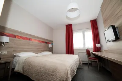Un ou plusieurs lits dans un hébergement de l'établissement Hotel Restaurant Le Coquelicot
