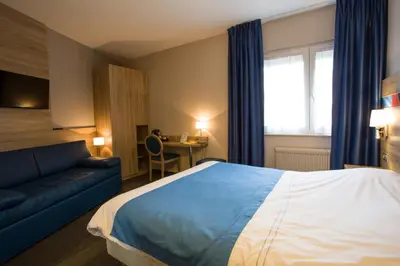 Un ou plusieurs lits dans un hébergement de l'établissement Hotel Restaurant Le Coquelicot