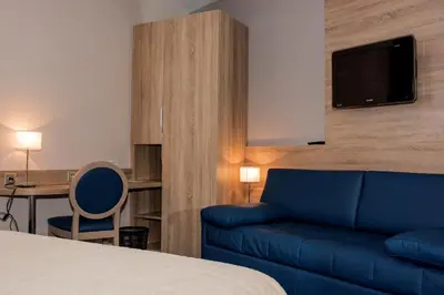 Télévision ou salle de divertissement dans l'établissement Hotel Restaurant Le Coquelicot